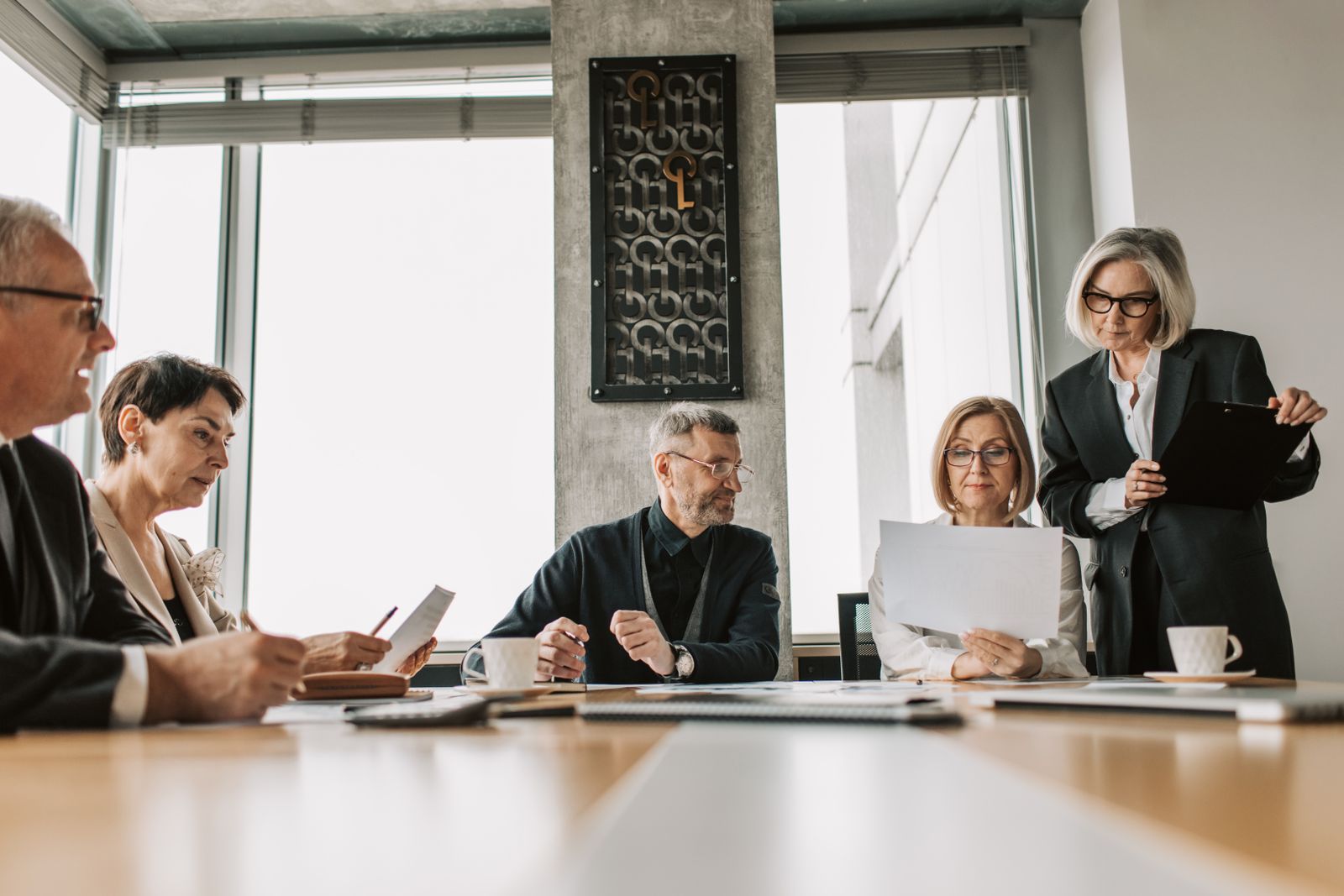 Senior executives reviewing strategy around a conference table