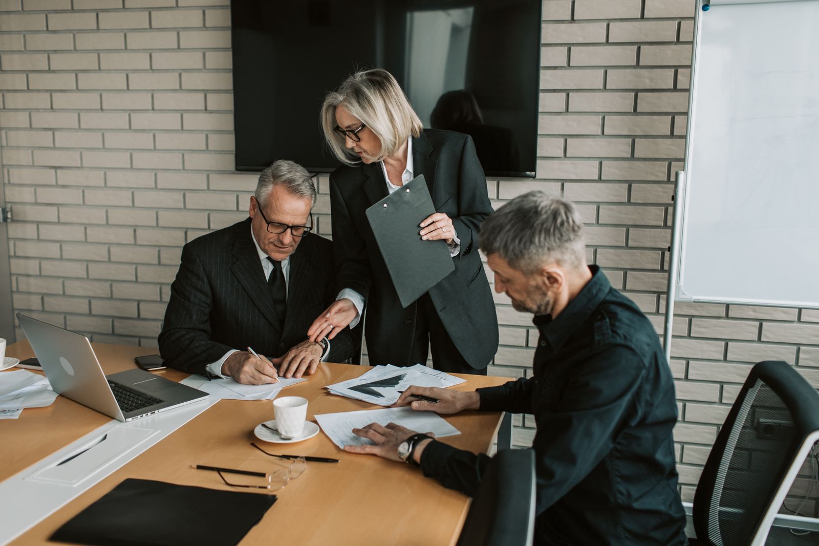 Senior executives reviewing transaction and implementation documents